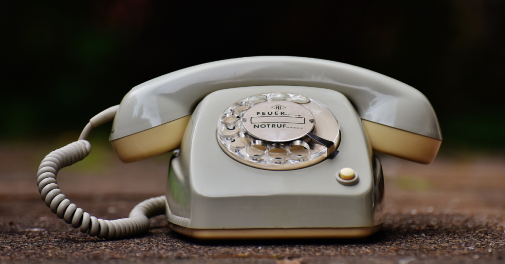 old rotary phone on wood table